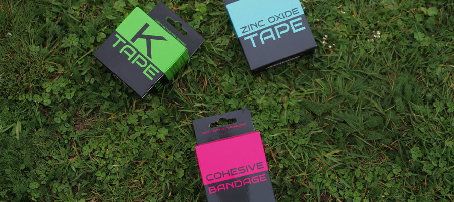 Bright pink cohesive bandage in black packaging with bold white text