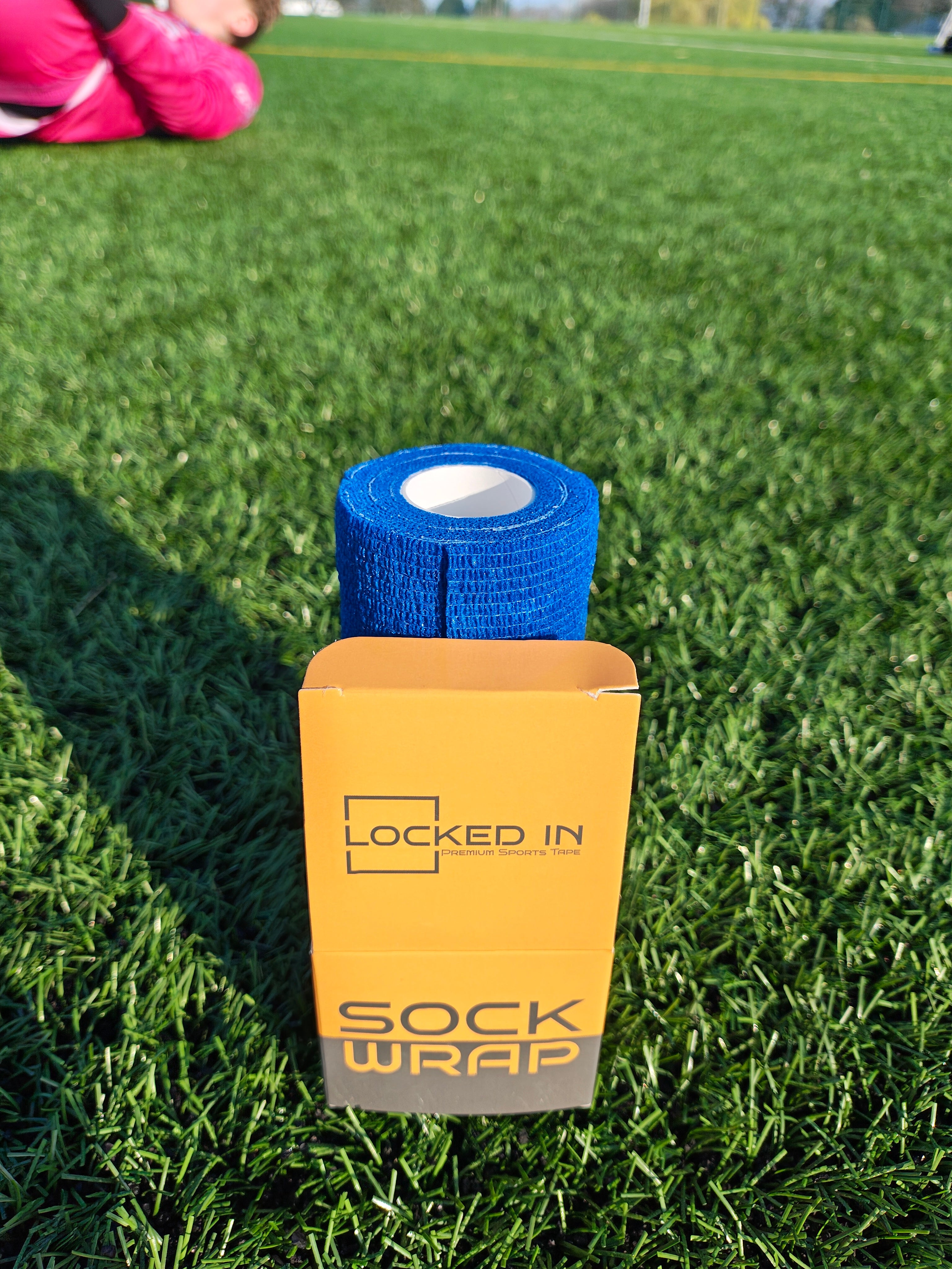 Blue athletic wrap in a yellow and gray ’locked in’ branded box.